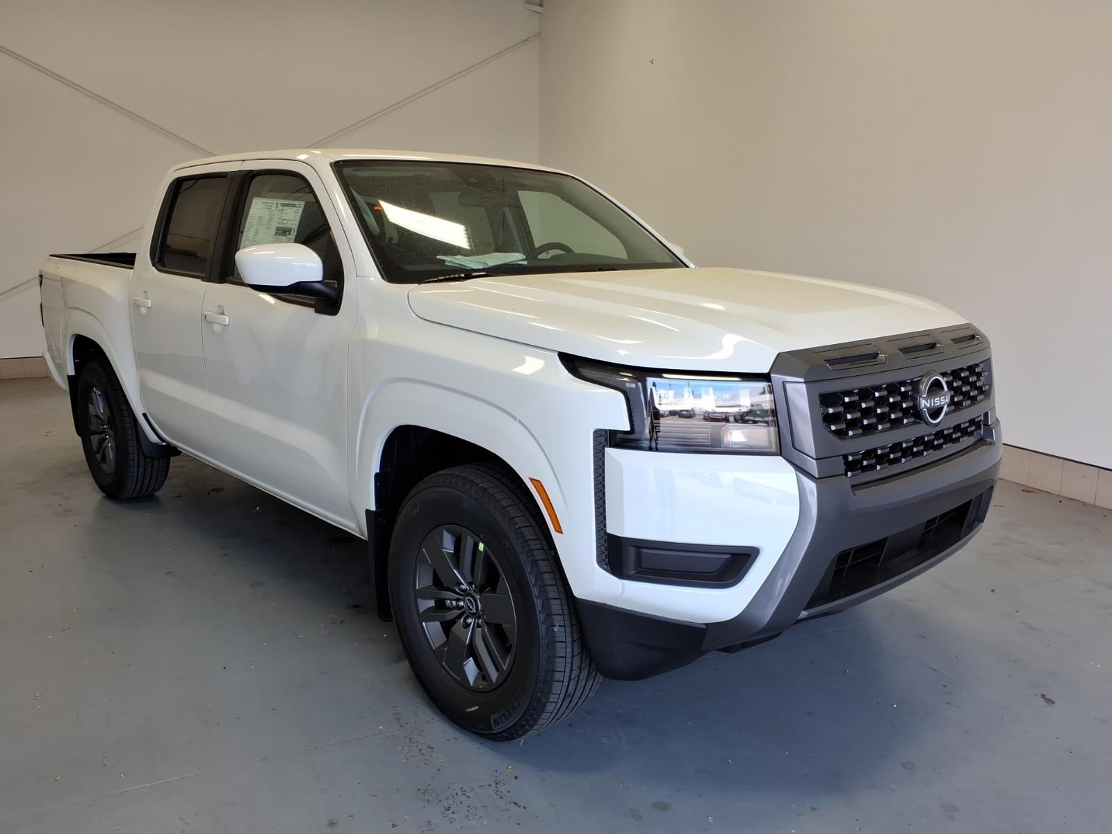 2026 Nissan Frontier SV in Glacier White Qak — front three-quarter view