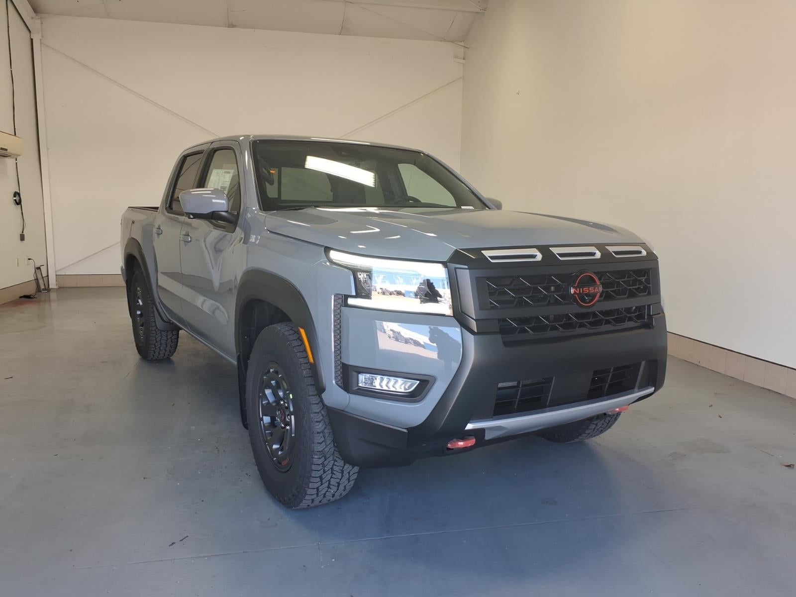 2026 Nissan Frontier PRO-X in Boulder Gray Pearl Kby — front three-quarter view
