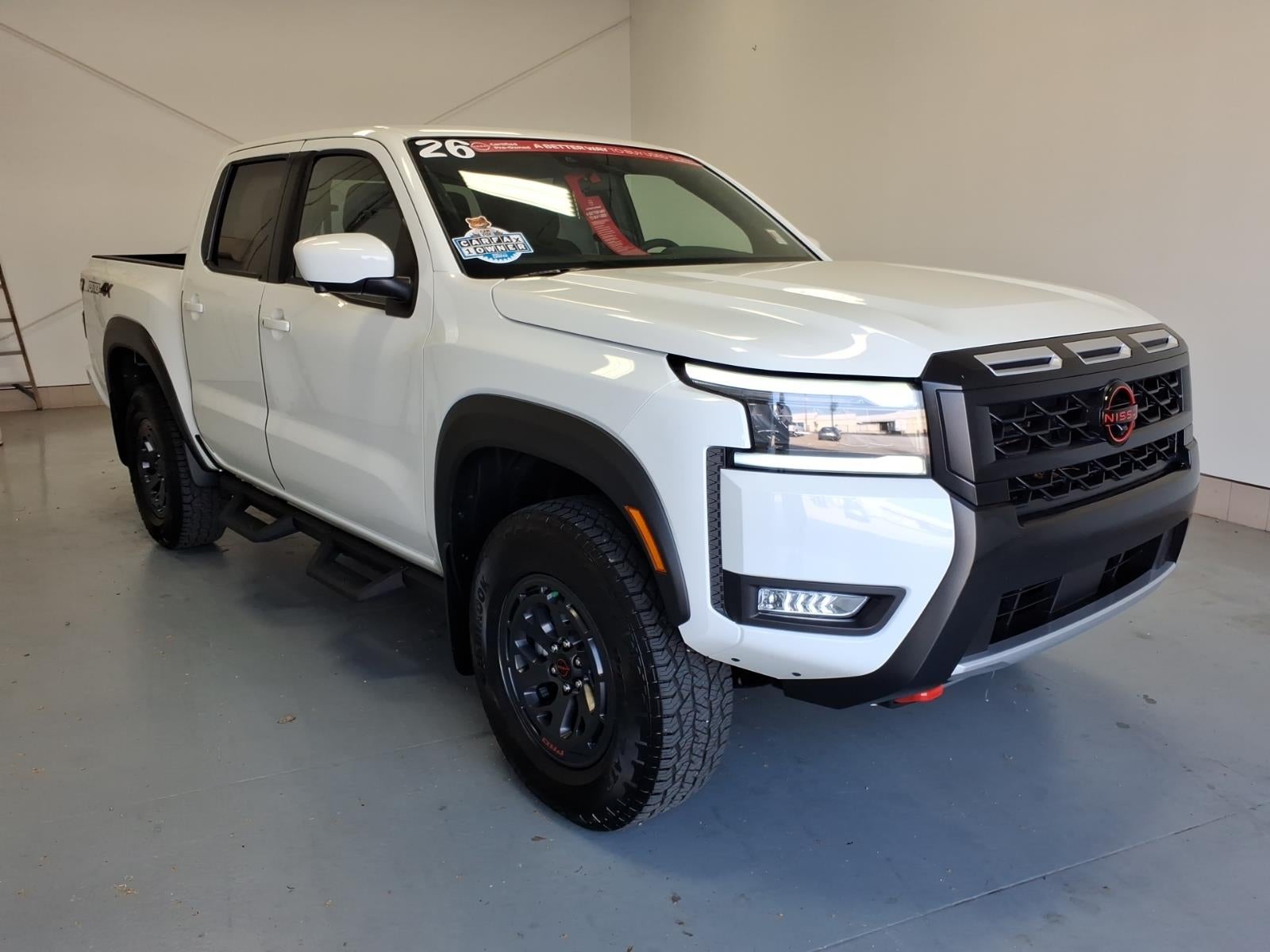 2026 Nissan Frontier PRO-4X in Glacier White (Qak) — front three-quarter view