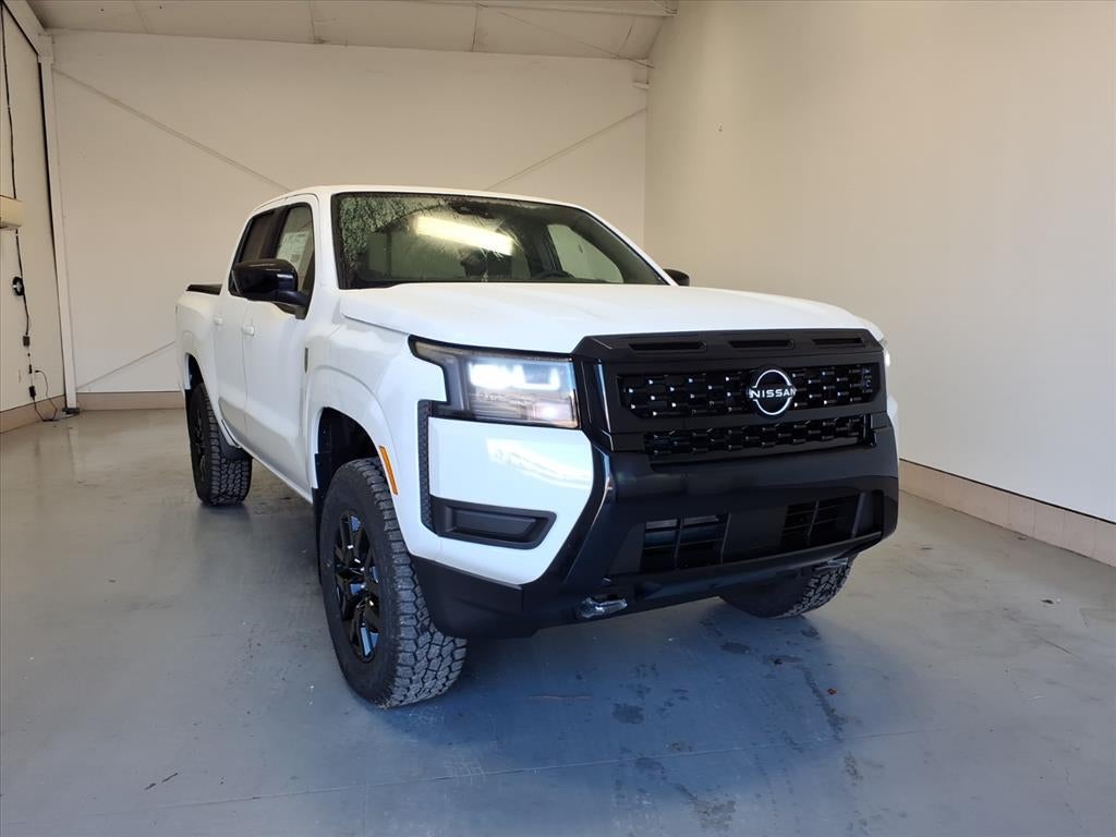 2026 Nissan Frontier SV in Glacier White Qak — front three-quarter view