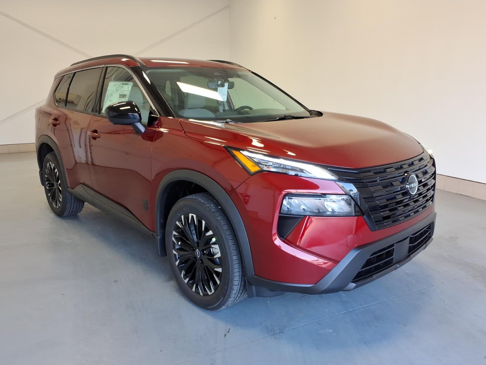2026 Nissan Rogue Dark Armor in Scarlet Red — front three-quarter view