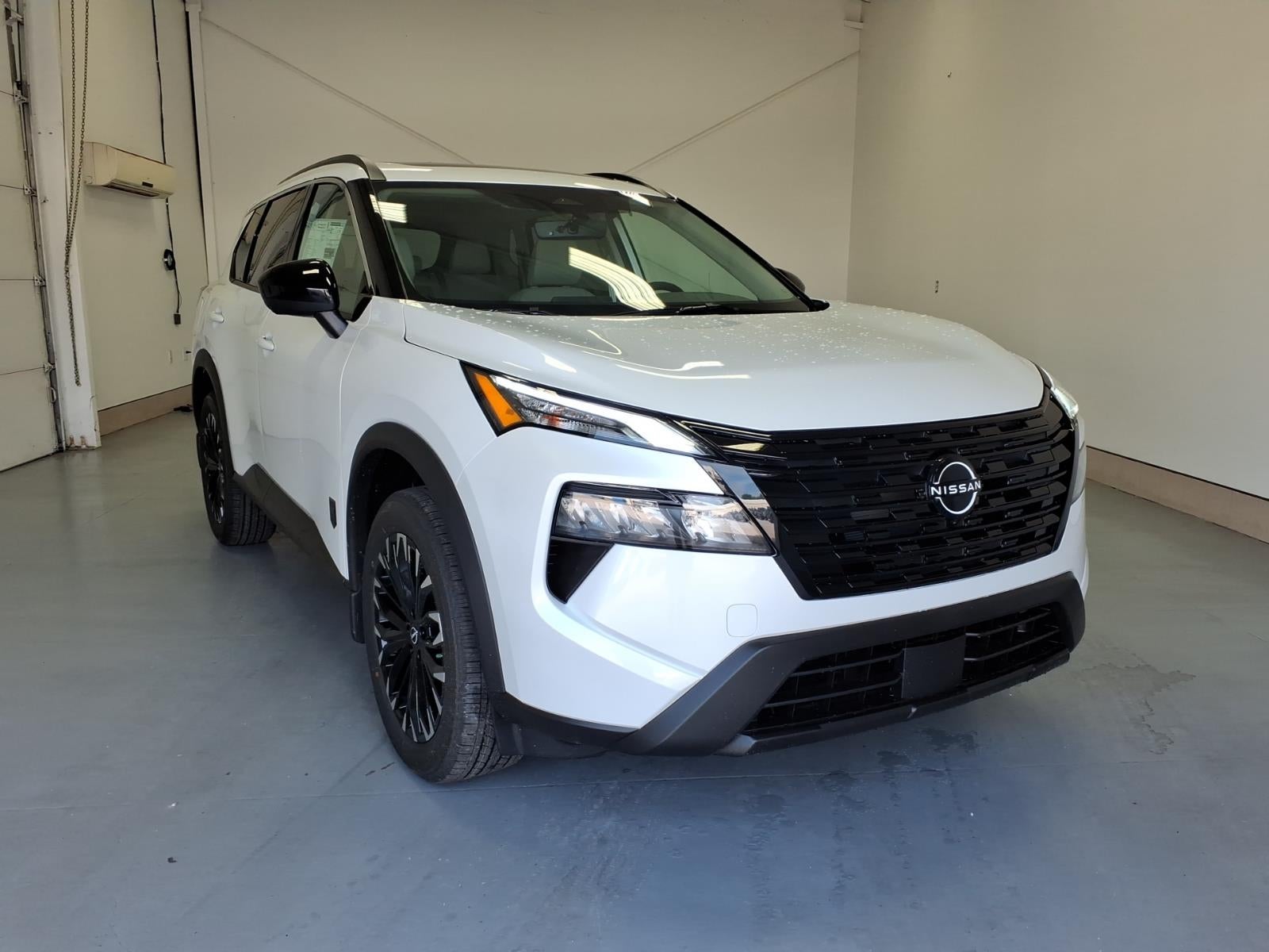 2026 Nissan Rogue Dark Armor in Everest White Pearl Tricoat — front three-quarter view