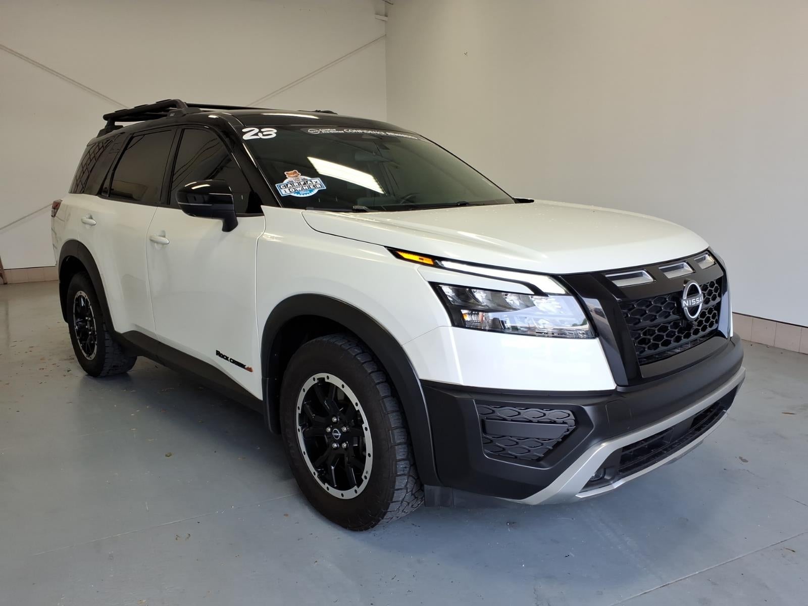 2023 Nissan Pathfinder Rock Creek in Glacier White (Qak) — front three-quarter view